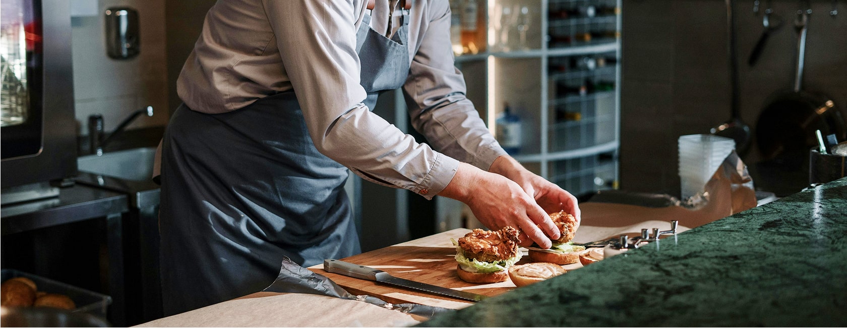 A hospitality team member preparing food for service